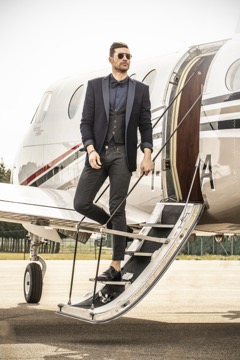 Man on the steps of a private jet